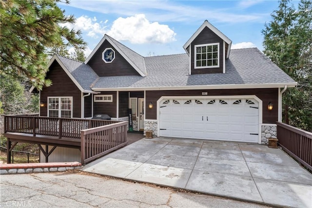 892 Breithorn Dr, Lake Arrowhead, CA 92352 - view of front facade with a garage, a deck, stone siding, a shingled roof, and concrete driveway