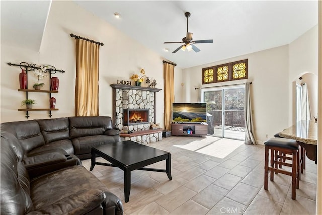 892 Breithorn Dr, Lake Arrowhead, CA 92352 - living area featuring a stone fireplace, a ceiling fan, arched walkways, and vaulted ceiling