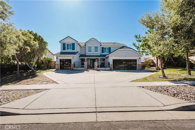 view of front of home with driveway, a garage, and stucco siding