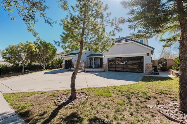 view of front of house featuring stucco siding, concrete driveway, an attached garage, and stone siding