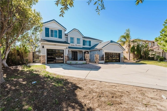 view of front of house featuring a gate, stucco siding, driveway, and fence