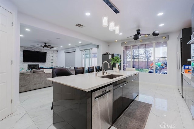 kitchen with marble finish floor, visible vents, stainless steel dishwasher, a sink, and modern cabinets