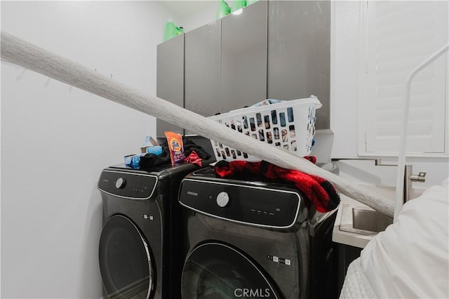 clothes washing area with separate washer and dryer