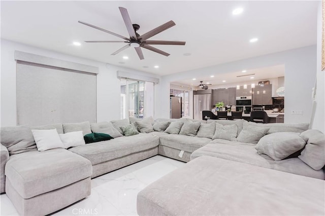 living room with a ceiling fan, recessed lighting, and marble finish floor