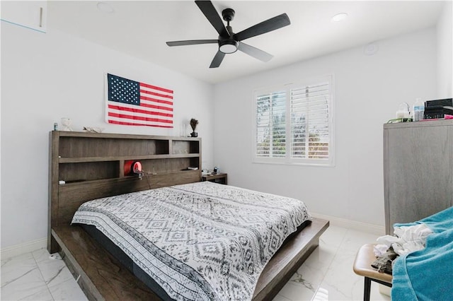 bedroom featuring ceiling fan, marble finish floor, and baseboards