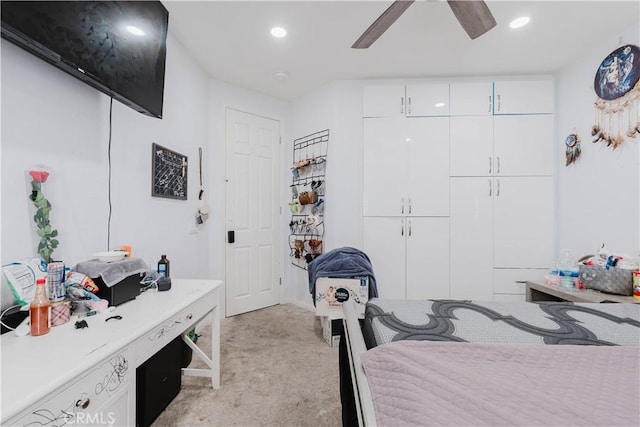 bedroom with light carpet, ceiling fan, a closet, and recessed lighting