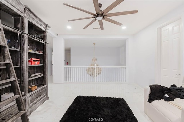 walk in closet with ceiling fan, marble finish floor, and visible vents