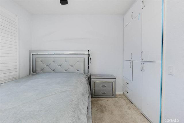 bedroom with ceiling fan and light colored carpet