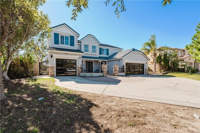 view of front of home featuring driveway, a gate, fence, and stucco siding