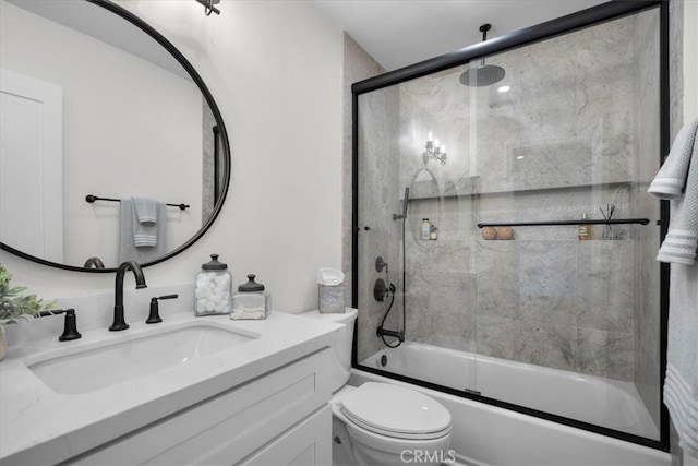 full bath with combined bath / shower with glass door, vanity, and toilet