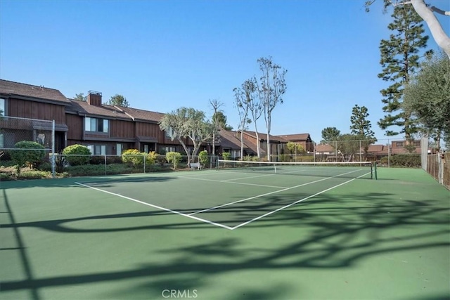 view of tennis court featuring fence