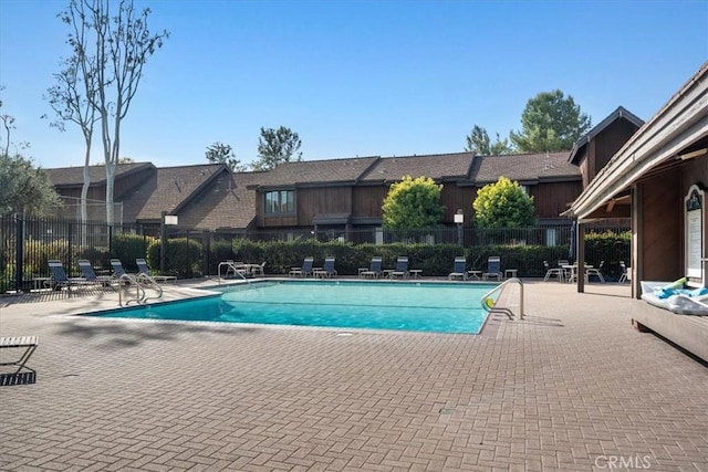 pool featuring a patio area and fence