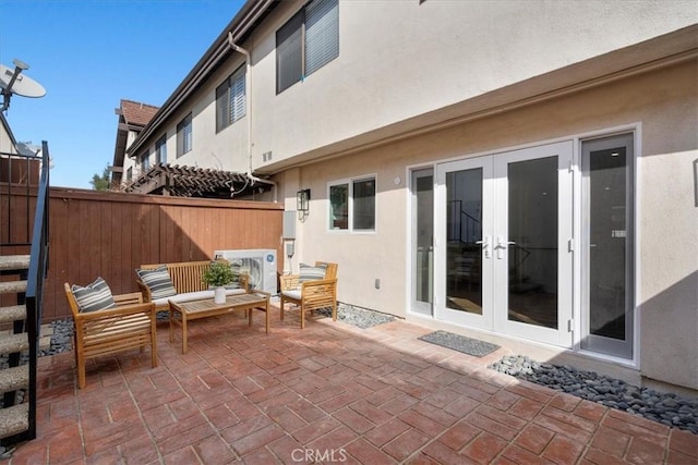 view of patio with french doors and fence