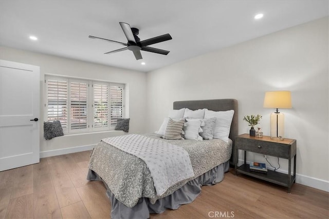 bedroom featuring ceiling fan, baseboards, wood finished floors, and recessed lighting