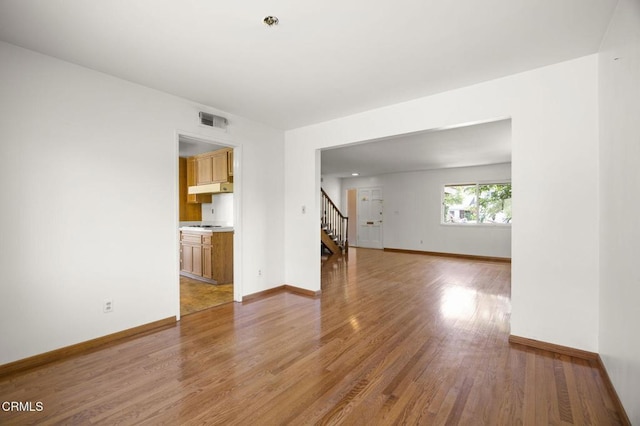 205 Bluefield Ave, Newbury Park, CA 91320 - spare room featuring stairs, light wood finished floors, and baseboards