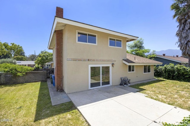 205 Bluefield Ave, Newbury Park, CA 91320 - rear view of house with stucco siding, a patio area, a chimney, and a mountain view