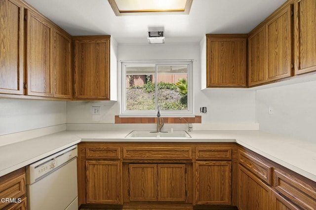 205 Bluefield Ave, Newbury Park, CA 91320 - kitchen featuring white dishwasher, a sink, light countertops, and brown cabinetry