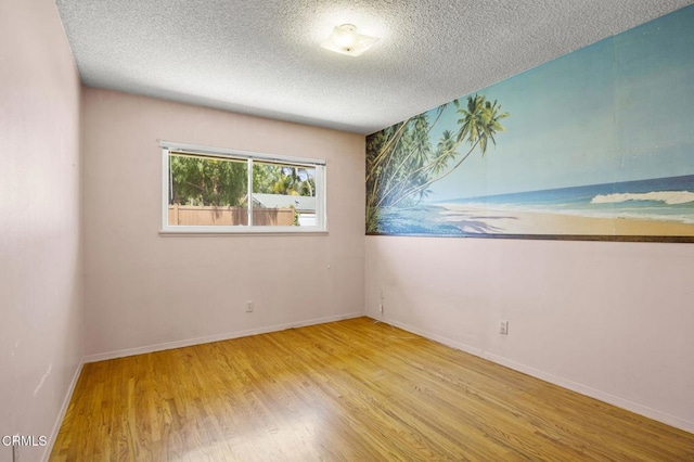 205 Bluefield Ave, Newbury Park, CA 91320 - unfurnished room featuring wood finished floors, a textured ceiling, and baseboards