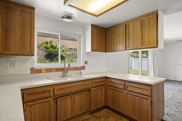 205 Bluefield Ave, Newbury Park, CA 91320 - kitchen with a peninsula, a sink, light countertops, and brown cabinetry