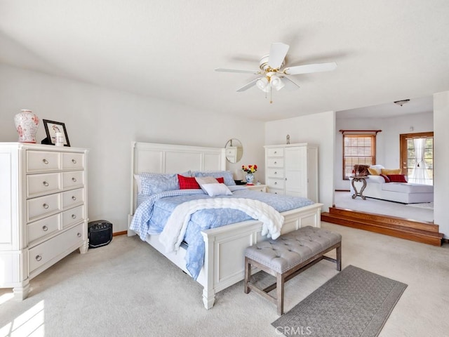 bedroom featuring light carpet and a ceiling fan