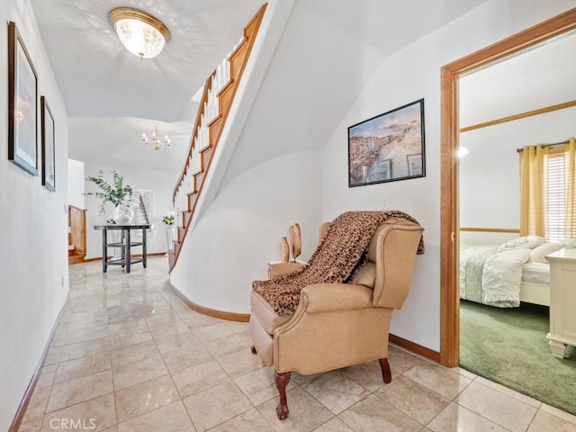 living area with light colored carpet, a notable chandelier, stairway, and baseboards