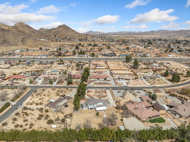 aerial view featuring a residential view, a mountain view, and a desert view