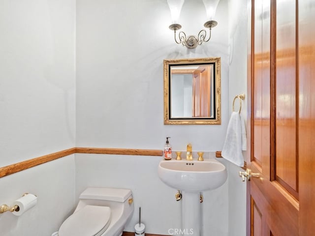 bathroom featuring toilet and a sink