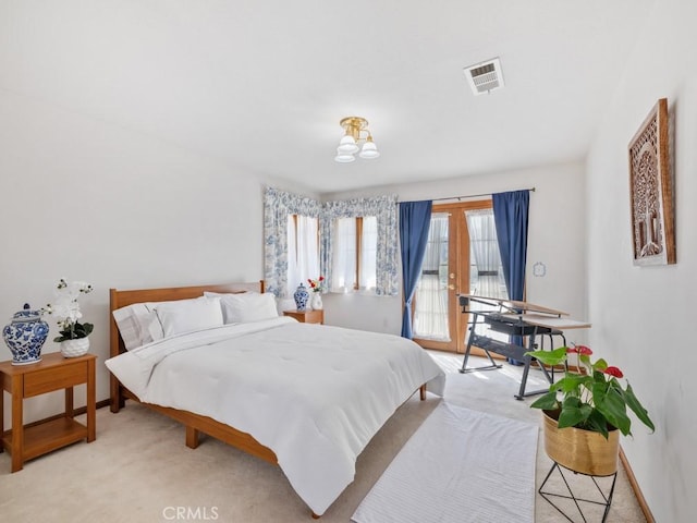 bedroom featuring access to exterior, light colored carpet, french doors, and visible vents