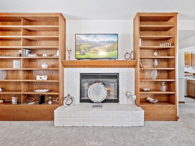 living area featuring carpet floors, a brick fireplace, and a textured ceiling