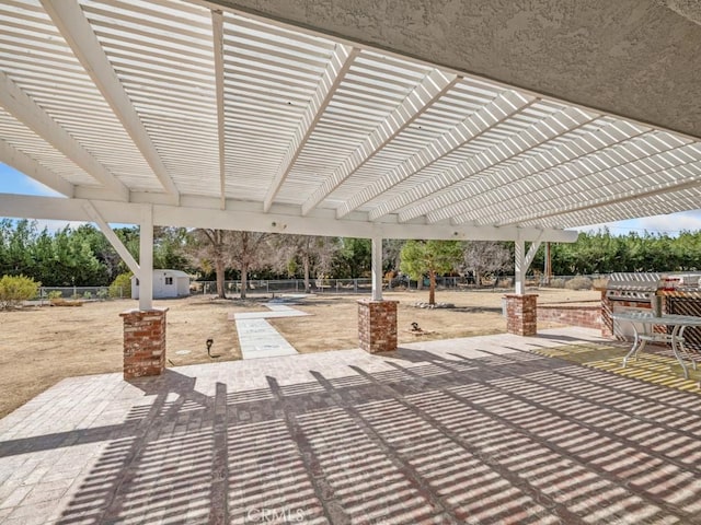 view of patio / terrace featuring an outbuilding, fence, and a pergola