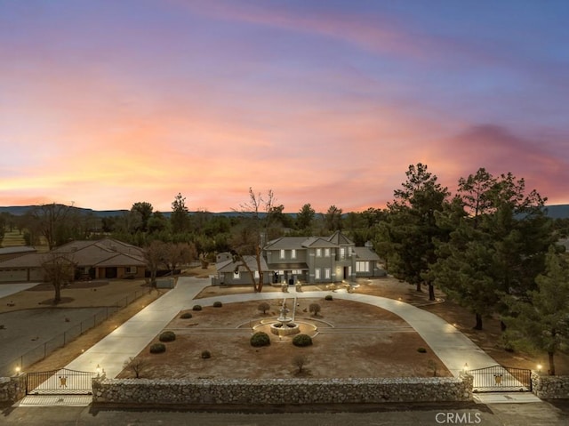 view of front of house with concrete driveway, fence, and a gate