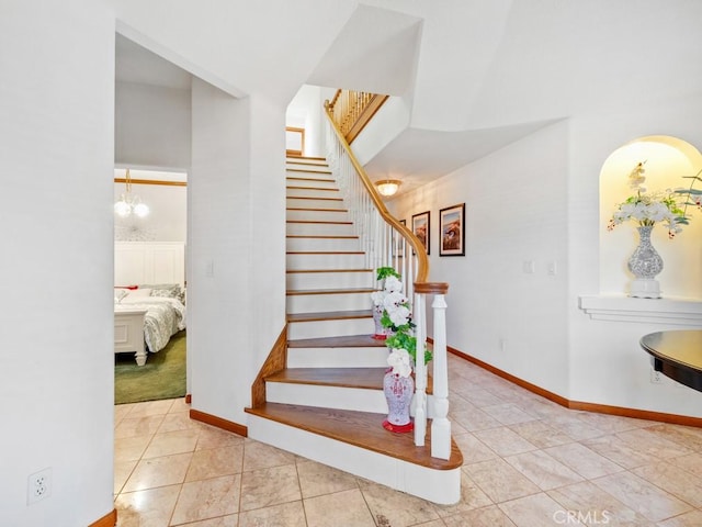 stairway featuring tile patterned flooring and baseboards