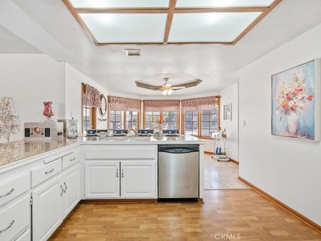 kitchen featuring white cabinets, dishwasher, ceiling fan, a textured ceiling, and a sink