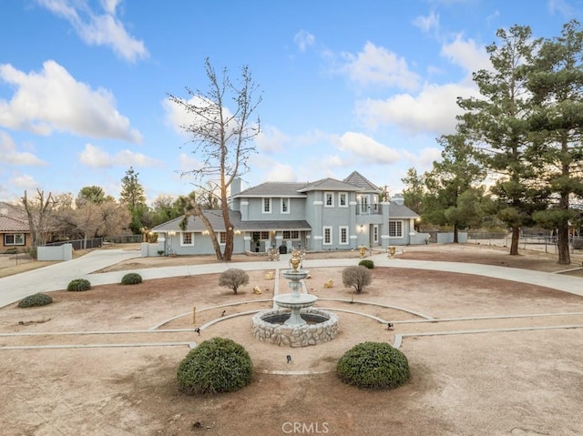 view of front of property with driveway and fence