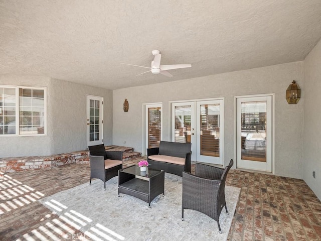 view of patio / terrace featuring ceiling fan, an outdoor living space, and french doors