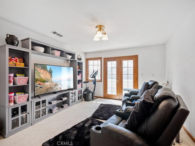 living room featuring carpet floors, french doors, and visible vents