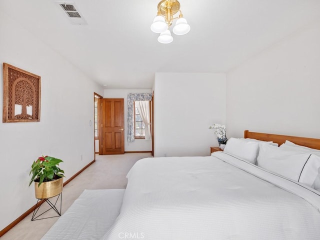 bedroom with light carpet, a notable chandelier, visible vents, and baseboards