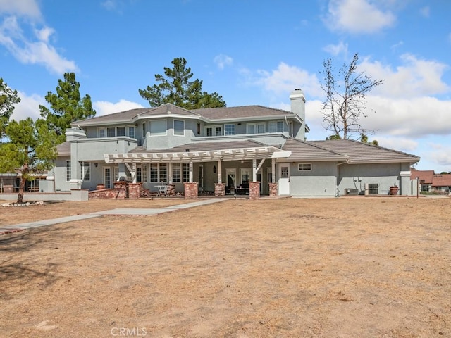 rear view of house featuring a patio area and a chimney