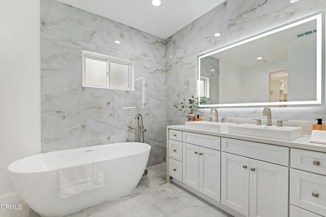 full bath with double vanity, visible vents, marble finish floor, and a sink