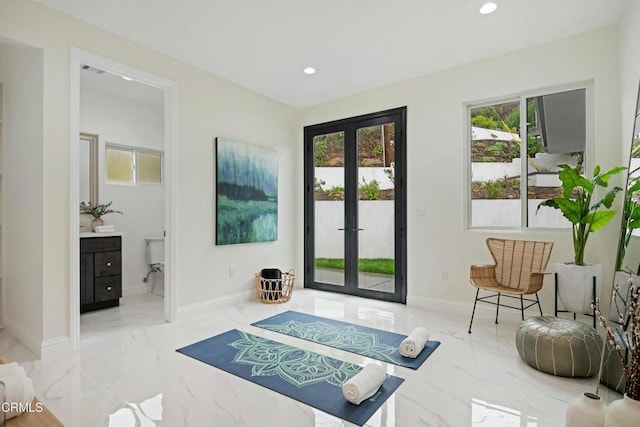 interior space with recessed lighting, plenty of natural light, marble finish floor, and french doors