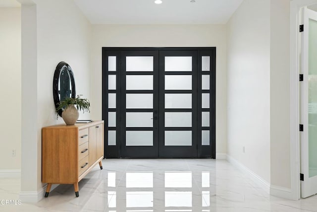 entryway featuring recessed lighting, baseboards, and marble finish floor