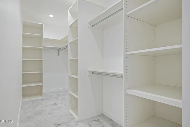 spacious closet with marble finish floor