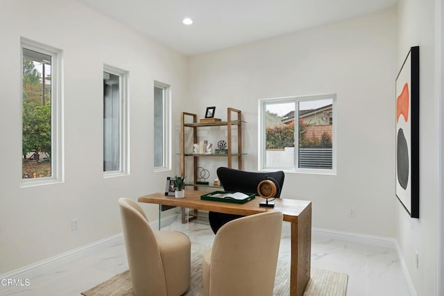 home office featuring a wealth of natural light, recessed lighting, marble finish floor, and baseboards