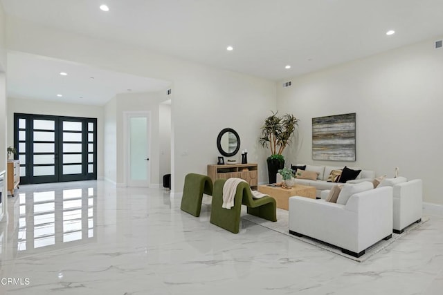 living area with recessed lighting, marble finish floor, and visible vents