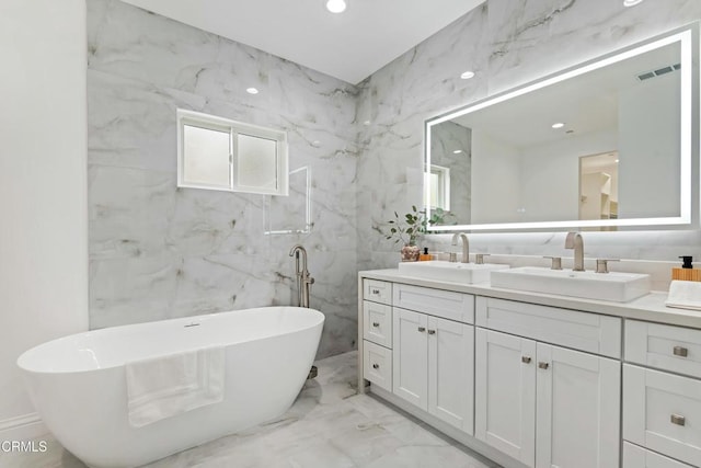 724 Via Arroyo, Ventura, CA 93003 - full bathroom with marble tiled flooring, double vanity, a freestanding bath, tile walls, and recessed lighting
