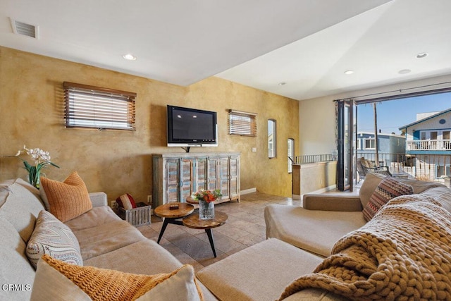 tiled living area with baseboards, visible vents, a wealth of natural light, and recessed lighting