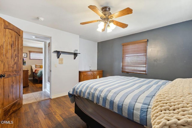 bedroom featuring ceiling fan, wood finished floors, and baseboards