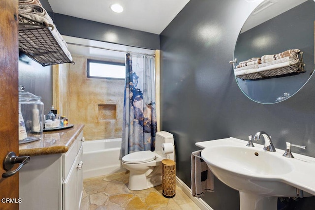 bathroom featuring toilet, a sink, visible vents, baseboards, and shower / tub combo with curtain