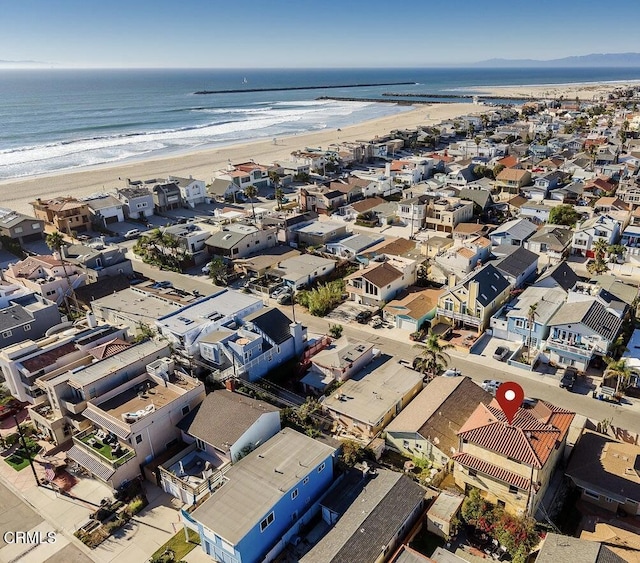 drone / aerial view featuring a beach view and a water view