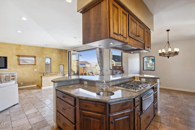 kitchen with baseboards, stone tile floors, stainless steel gas cooktop, and a warming drawer